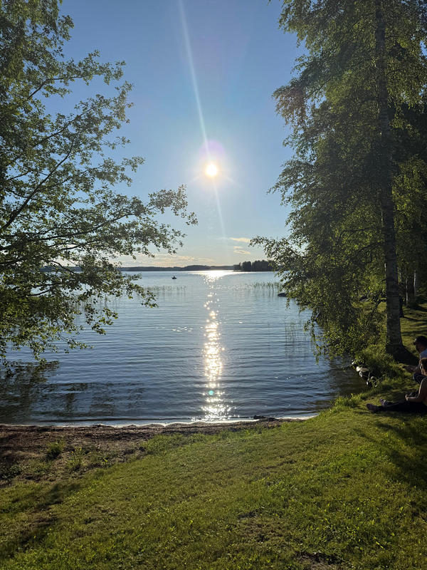 sonne funkelt über und spiegelt sich im see